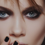 A model with blue eyes displaying a black nails on lips