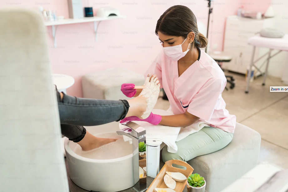 Nail technician providing a spa treatment