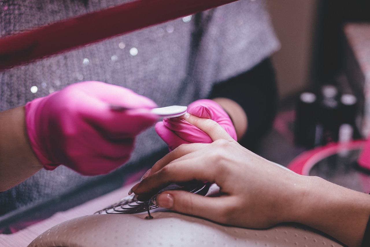 Nail Technician filing a woman's right hand