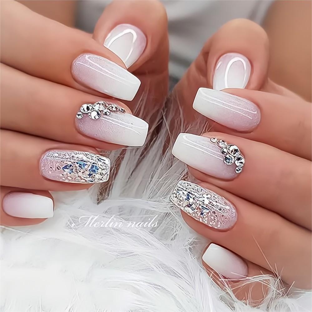 Beautiful nails painted in white with diamond design