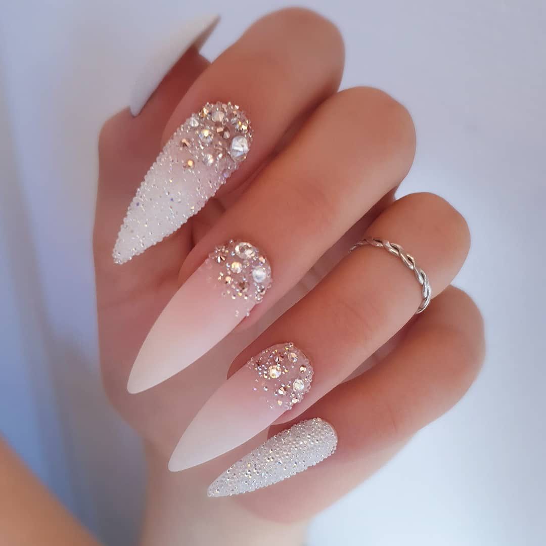 Woman's beautiful finger nails with diamonds