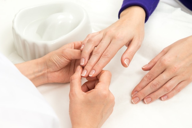 Nail technician analyzing hands