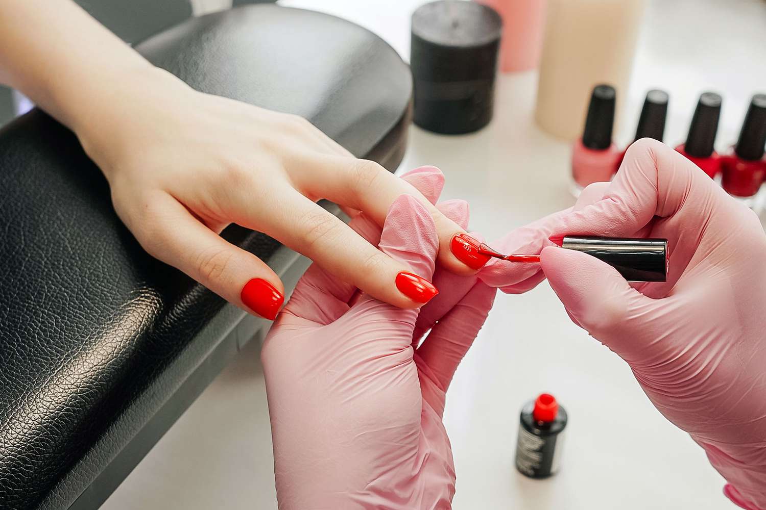 Woman getting red finger nail polish