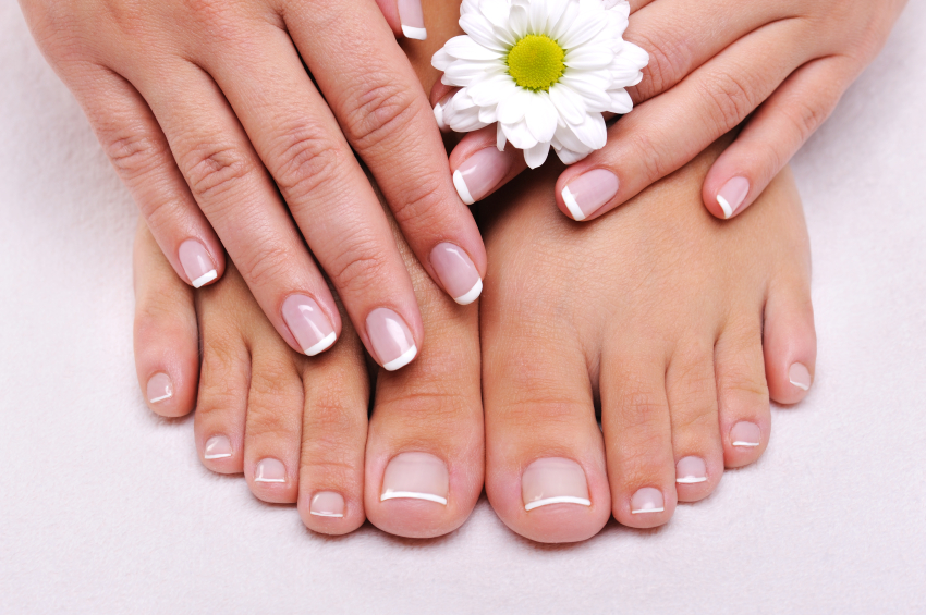 Beautiful hands and feet with a daisy