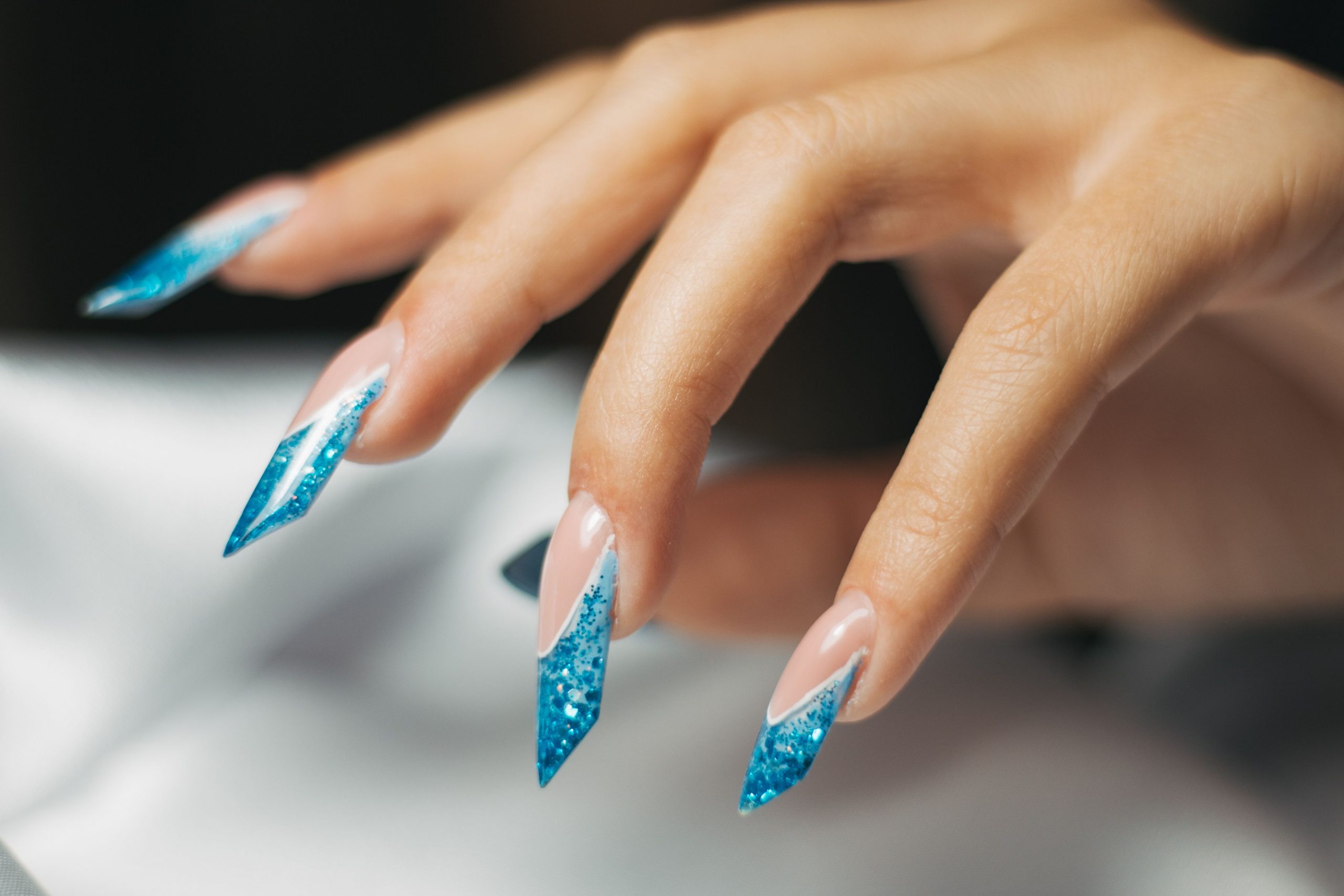 Finger nails with blue polish design