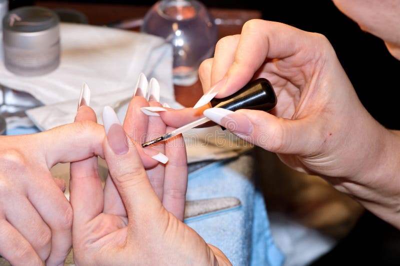 Manicurist working on woman's nails