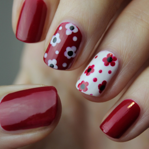 Red nails painted in red with flowers
